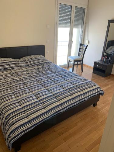 a bedroom with a bed and a chair in it at Appartment near Center in Korinthos