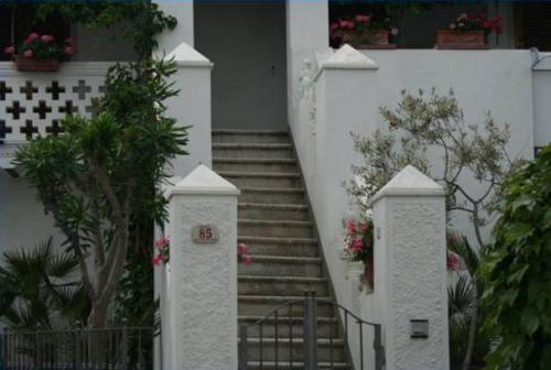 a set of stairs leading up to a house with flowers at Villino Oliva in Pomonte