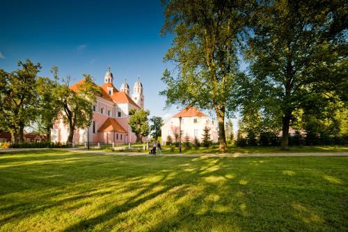 a large yard with a large house and trees at Domek Trolla in Sieraków