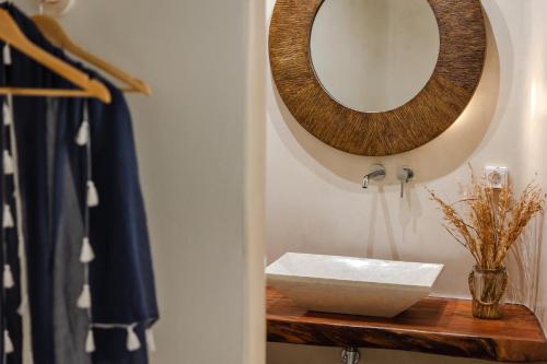 a bathroom with a sink and a mirror on a counter at Casa di Mare Luxury Villas in Imerovigli