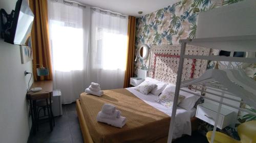 a small bedroom with a bed with towels on it at Boutique Hotel Ferrara in Ferrara