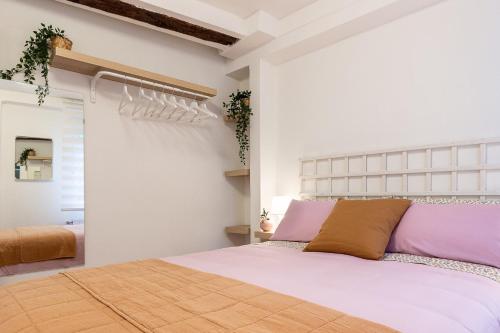 a bedroom with a large bed with purple and white at Apartamento. El Rincón de Cañadío in Santander
