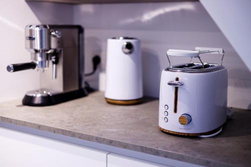 two toasters sitting on a counter in a kitchen at Gîte La Petite Ourse - gîte de charme citadin in Andenne
