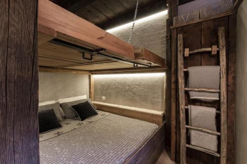 a small room with a bed and a bunk bed at La Meison des Marronniers CIR 0016 in Saint-Rhémy-en-bosses