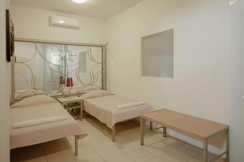 a living room with two beds and a table at Villa Emma in Gerani