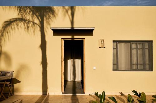 a door to a building with palm trees in front of it at Dar Meha in Marrakech
