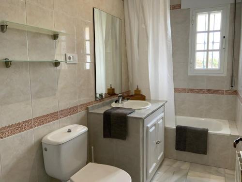 een badkamer met een toilet, een wastafel en een bad bij Villa dos Torres in Campano