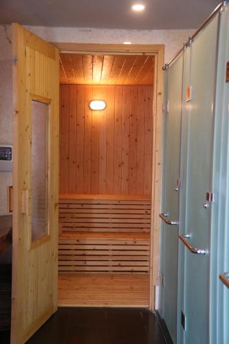 a wooden sauna with a tub in a room at Hoi An Eco Lodge & Spa in Hoi An