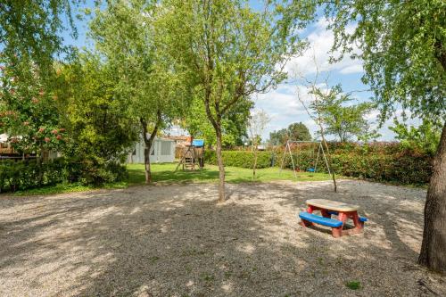 a park with a playground with a swing at Casolare dei Fiori - Calla in Montecarlo