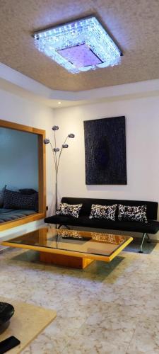 a living room with a couch and a skylight at APPARTEMENTS NIA CONFORT, Plein centre ville, avec TERRASSE in Fès