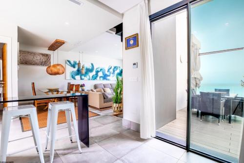 a dining room and living room with a view of the ocean at ON Village in Matalascañas