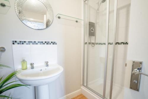 a bathroom with a sink and a shower at Saltbox Stays - 3 Bed with off-street parking, fast Wifi, sleeps 7, Central location in Ashby de la Zouch