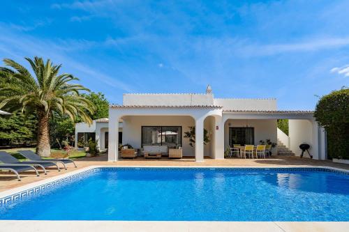 a villa with a swimming pool and a house at Casa Luzerna in Carvoeiro