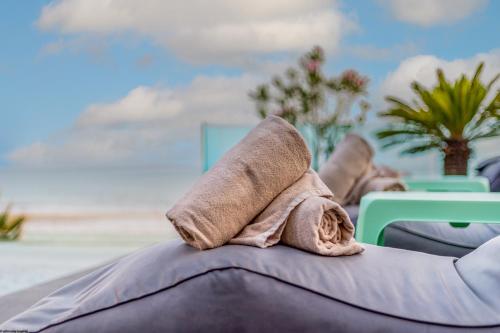 a towel sitting on the back of a chair at the beach at ON Village in Matalascañas