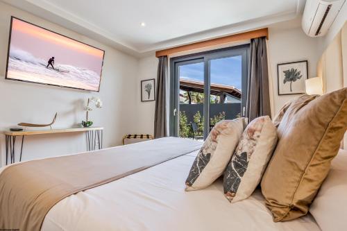 a bedroom with a white bed with a window at ON Village in Matalascañas
