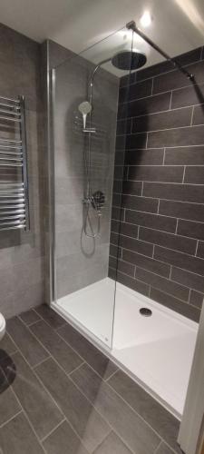 a shower with a glass door in a bathroom at Earl Street 122 in Sheffield