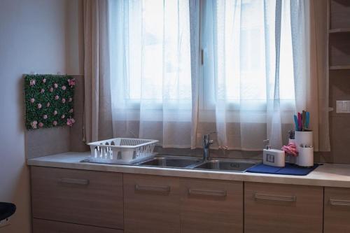 a kitchen counter with a sink and a window at Λabirinthia in Athens