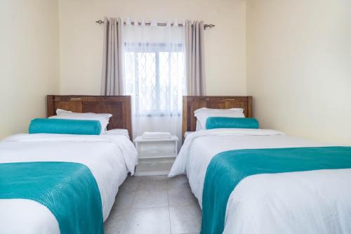 Postel nebo postele na pokoji v ubytování Villa by the beach Mombasa
