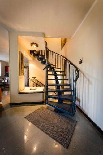 a spiral staircase in a house with a rug at San Gaudenzio 16 in Ivrea