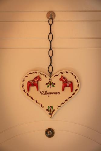 a heart shaped sign with two horses on a wall at San Gaudenzio 16 in Ivrea