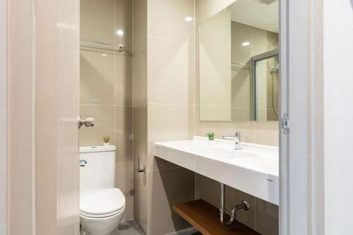 a bathroom with a toilet and a sink and a mirror at 4-mrt rame9 400m-Infinity pool/gym/shopping mall 