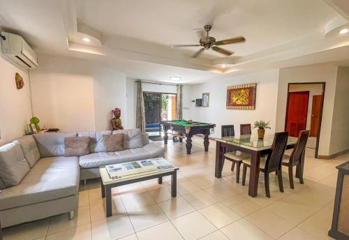 a living room with a couch and a pool table at GARDEN VILLA - PATTAYA HOLIDAY HOUSE WALKING STREET 4 bedrooms in Pattaya South