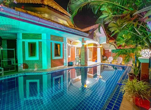 a swimming pool in a villa with a house at GARDEN VILLA - PATTAYA HOLIDAY HOUSE WALKING STREET 4 bedrooms in Pattaya South