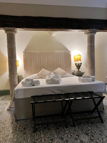 a bedroom with a bed with towels on it at Casa Modica - Luxury rooms in Noto