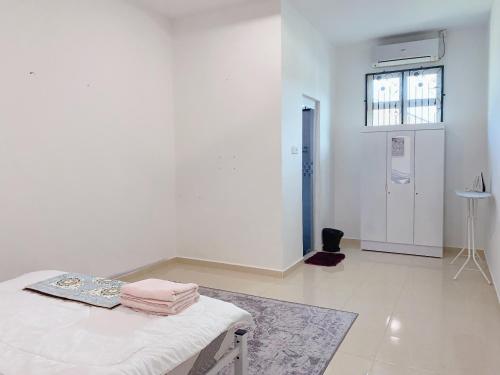 a white room with a bed and a window at 4 bedrooms house with Private Pool ! in Kota Bharu