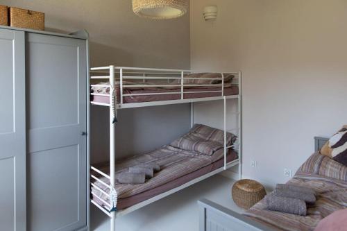a room with two bunk beds in a room at BlueWater Apartment in Mikołajki