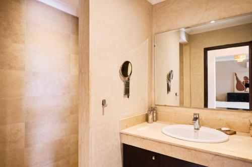 a bathroom with a sink and a mirror at Dar Meha in Marrakech