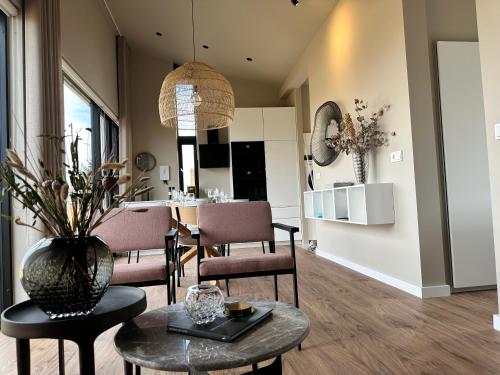 a living room with a table and a dining room at Urriðafoss Waterfall Lodges in Selfoss