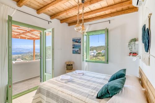 a bedroom with a bed and a balcony at Magic Villa With Swimming Pool in Paros in Lefkes