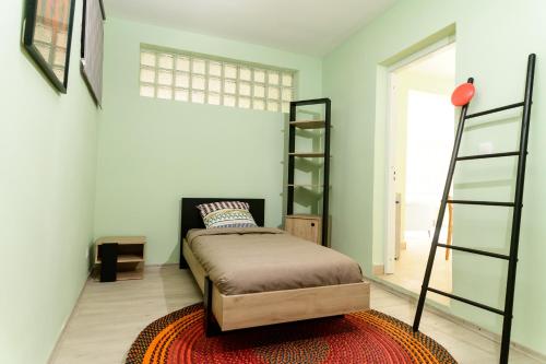 a bedroom with a bed and a book shelf at Newly renovated & cozy apartment in Antananarivo