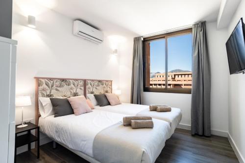 Postel nebo postele na pokoji v ubytování Sur Suites Palmeras 8