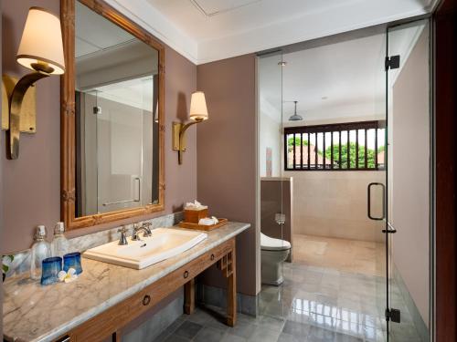 a bathroom with a sink and a shower at Sudamala Resort, Sanur, Bali in Sanur