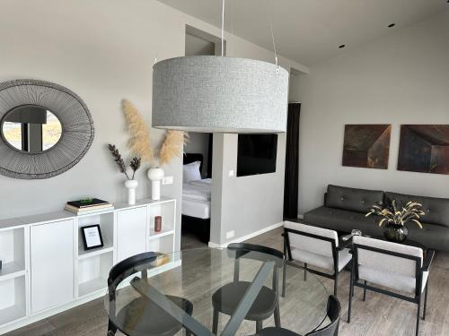 a living room with a glass table and a couch at Urriðafoss Waterfall Lodges in Selfoss
