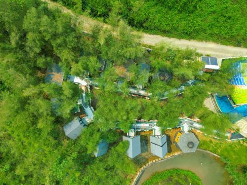 an overhead view of a house with a pool and trees at MEDDOM Park in Cao Phong