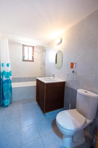 a bathroom with a toilet and a sink at Villa Med. Coast in Argaka