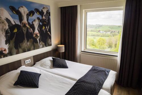 a hotel room with two beds and a large window at Best Western Hotel Slenaken in Slenaken