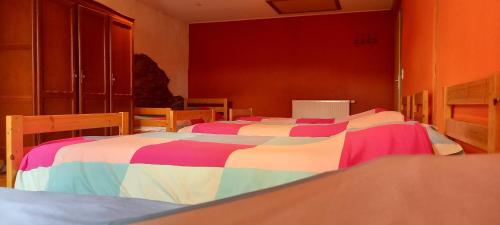 a bedroom with two beds with colorful blankets at Gîte L'Olivier à Filly - Nadrin, entre Houffalize et La Roche-en-Ardenne in Houffalize