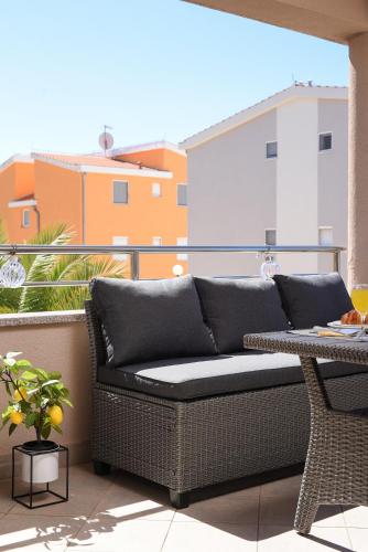 a couch sitting on top of a balcony at Sunset Beach Suites in Kožino