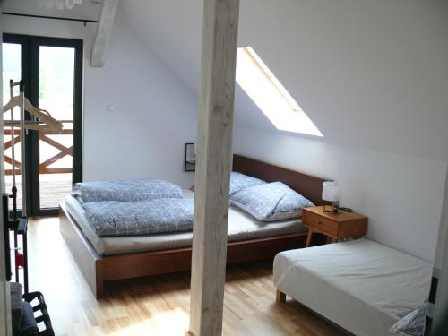 a bedroom with two beds and a skylight at Dom z Zielonego Wzgórza 