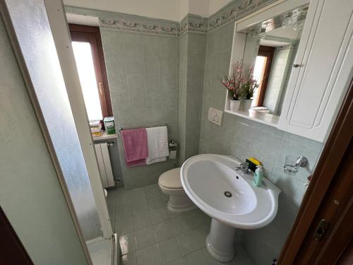a bathroom with a sink and a toilet and a mirror at Il Girasole - Apartment in Avezzano