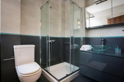 a bathroom with a shower and a toilet and a sink at Eucalyptus suite sea view in Karavomylos