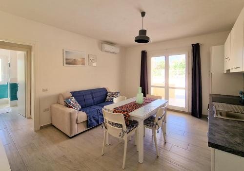 een woonkamer met een tafel en een bank bij Residenza Solari in La Maddalena