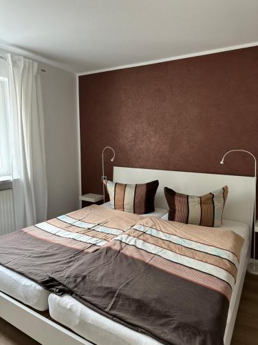 a bedroom with a large bed with two pillows at NEU ... in 2 min. am Bodensee in Überlingen
