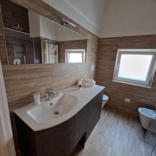 a bathroom with a sink and a mirror at Dimora Ketty in Noci