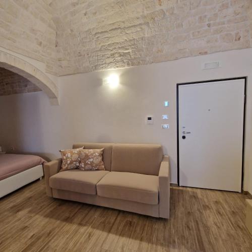a living room with a couch and a door at Dimora Ketty in Noci