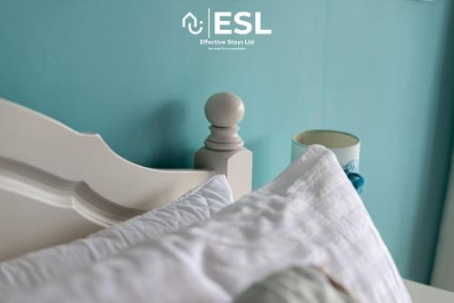 a close up of a bed with a pillow and a bottle at Beautiful En Suite 5 Bedroom Home with Sea Views in New Quay